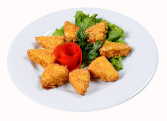 Appetizing fried chicken nuggets with tomatoes
