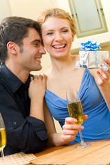 Young couple celebrating with champagne at home