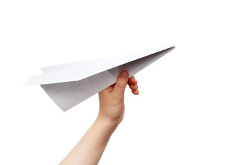 Child's hand launching white paper airplane