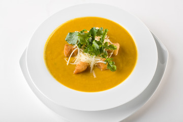 Pumpkin soup served with croutons and parmesan cheese