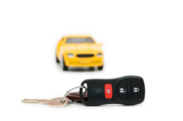 Car keys and car at background isolated on white