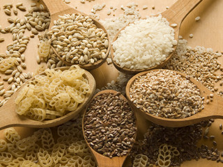 Wooden spoons with different kinds of groats. Shallow DOF.