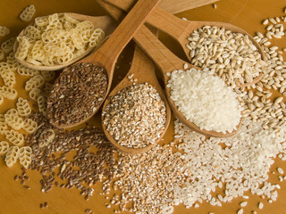 Wooden spoons with different kinds of groats. Shallow DOF.