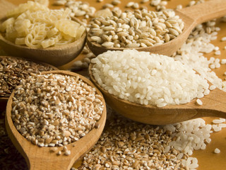 Wooden spoons with different kinds of groats. Shallow DOF.