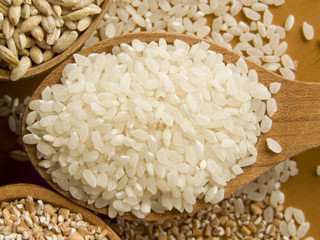 Wooden spoon with rice. Shallow dof.
