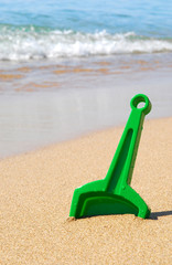Toy shovel in sand