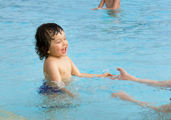 Little boy in pool.