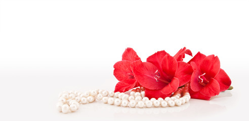 Fototapeta na wymiar Branch of beautiful flowers and necklace from pearls