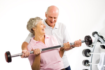 Mature older couple lifting weights