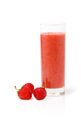 A glass of strawberry smoothie surrounded by fresh berries
