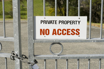 Private Property - No Access Sign on a Padlocked Gate