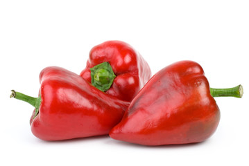 Three red sweet peppers