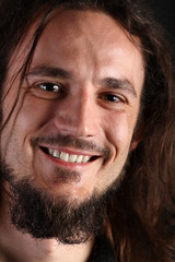 Portrait of smiling young man with long hair