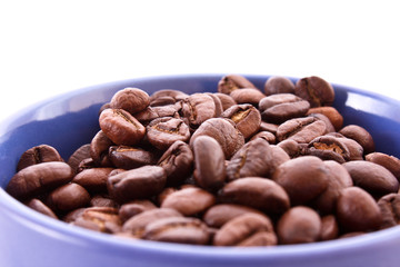 Coffee beans in blue cup isolated on white