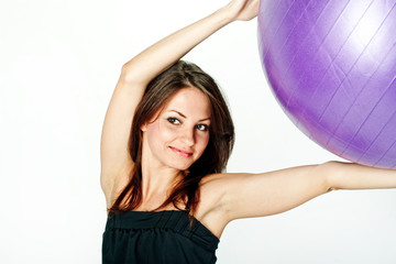 Fototapeta premium Young woman on white background in a fitness pose