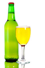 Glass of beer in the front with foam with green bottle of beer