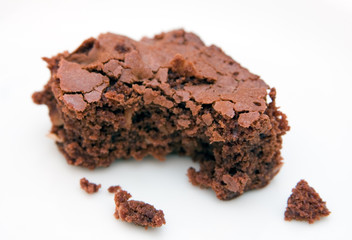 Brownie with bite-marks isolated on a white background