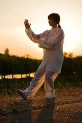 Abwaschbare Fototapete Kampfkunst woman in white suit make's taiji chuan exercise - 10