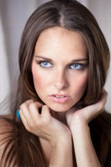 Obraz premium Beautiful Young Woman Holding Her Hair