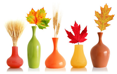Colorful fall leaves and wheat in vases