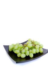 bunch of green grapes on a platter