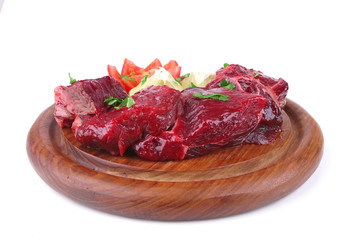 small beef chunks on wooden plate
