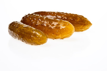 Three pickled cucumbers isolated on white background.