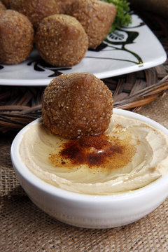 Arab fried kibbe dipped in yahine sauce with okive oil paprika