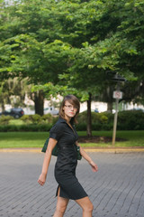 Female wearing glasses walking on cobblestone street