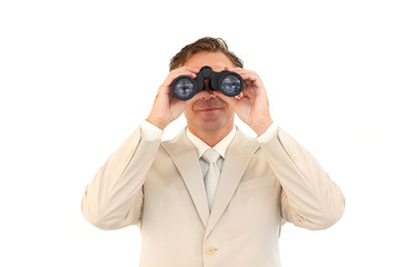 Serious businessman using binoculars