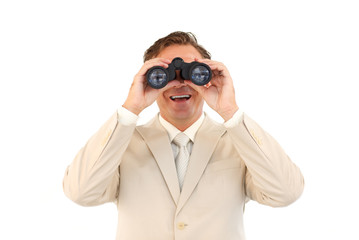 Smiling businessman looking through binoculars