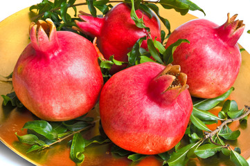 ripe pomegranates on a gold plate