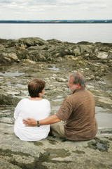 Couple discussing by water