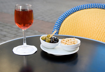 Parisian street cafe table with aperitif and nibbles