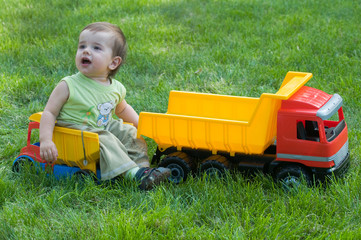 baby with toy trucks