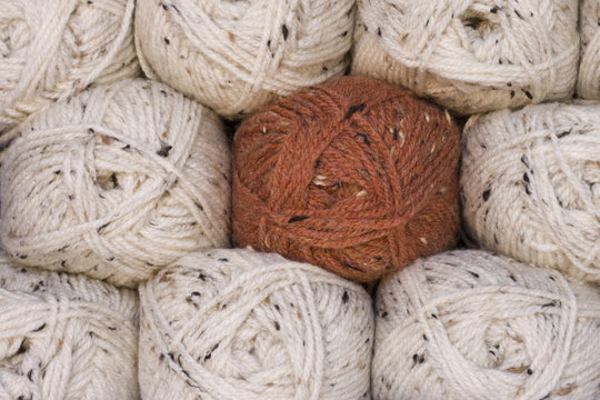 Balls of wool with an odd rust one