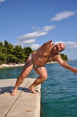 men jumping into the water