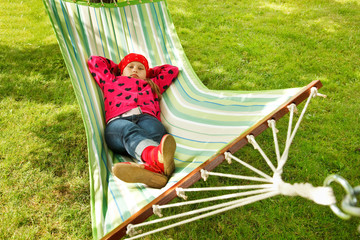 Little girl sleeping in hammock