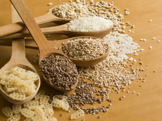 Wooden spoons with different kinds of groats. Shallow DOF.
