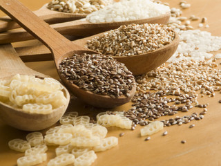 Wooden spoons with different kinds of groats. Shallow DOF.