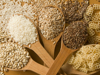 Wooden spoons with different kinds of groats. Shallow DOF.