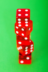 Red dice against green background - shallow DOF