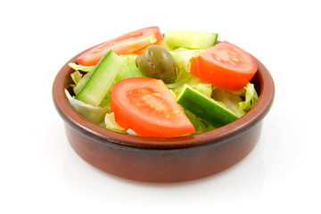 brown little bowl with fres salad on white background