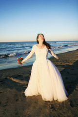 Fototapeta na wymiar Happy bride on a beach