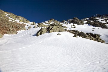 snow slope with big rocks