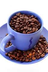Blue coffee cup and roasted brown coffee beans