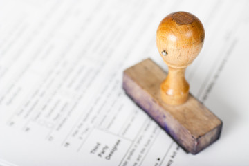 Old and very used wooden Rubber Stamp on form