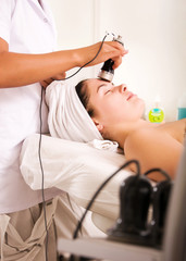 Young woman getting skin cleaning at beauty salon (shallow dof)