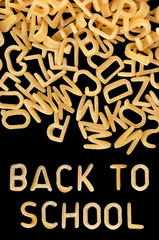 Back to school written in kids alphabet soup pasta.