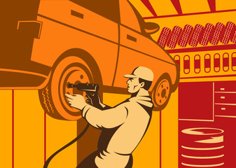 Automobile mechanic working on car